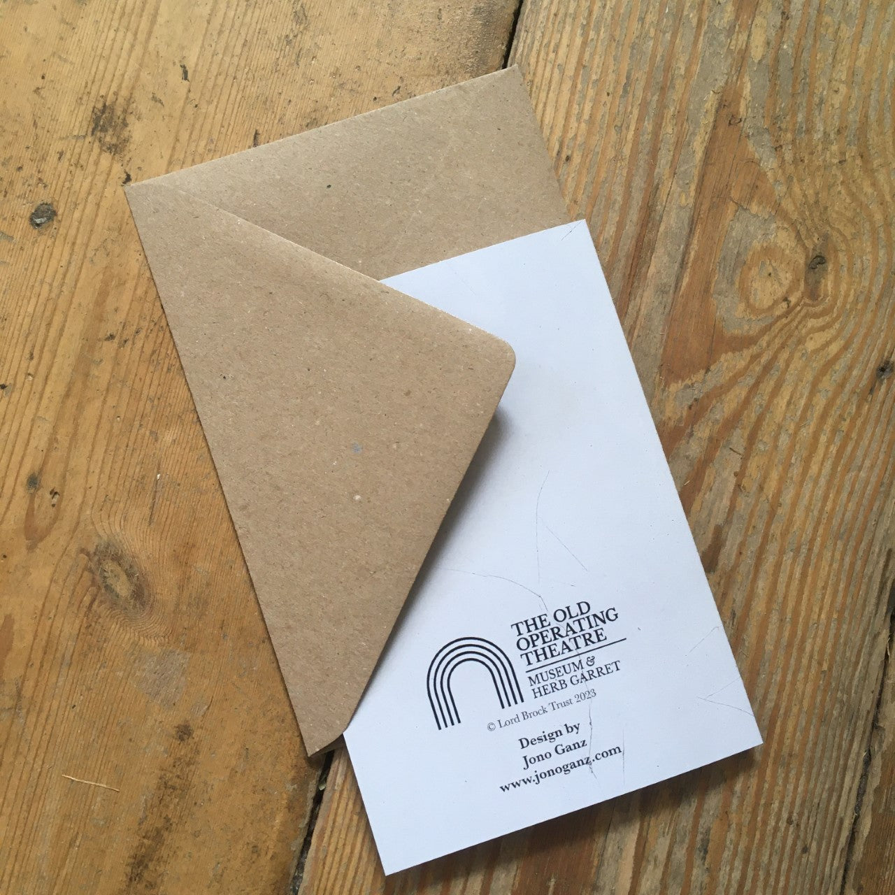 Back of a greeting card tucked into a brown envelope