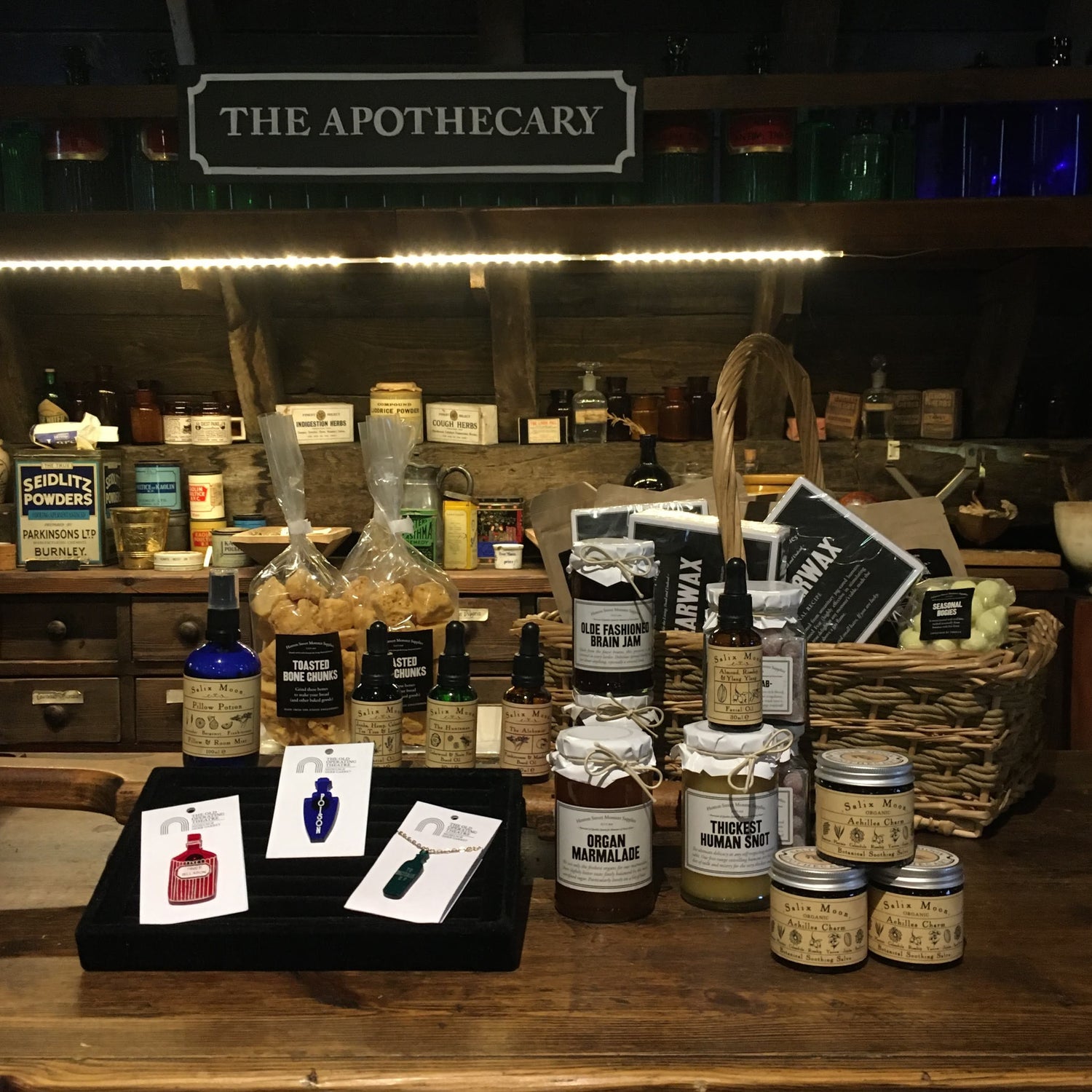 The museum's apothecary counter filled with shop products, including jewellery, jam, balms, tinctures and sweets