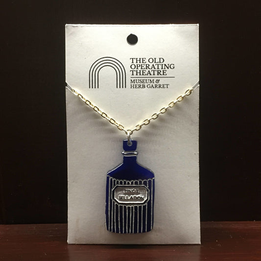 Blue pendant in the shape of a bottle with the label 'tinct. belladon'