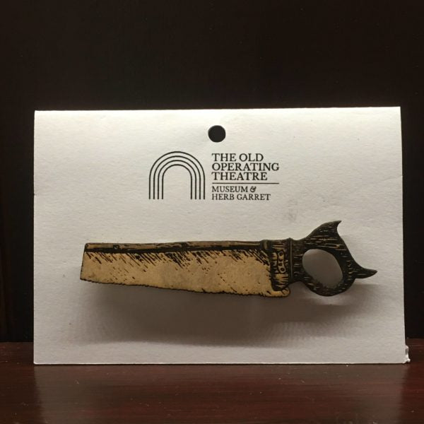 Wooden brooch in the shape of a saw