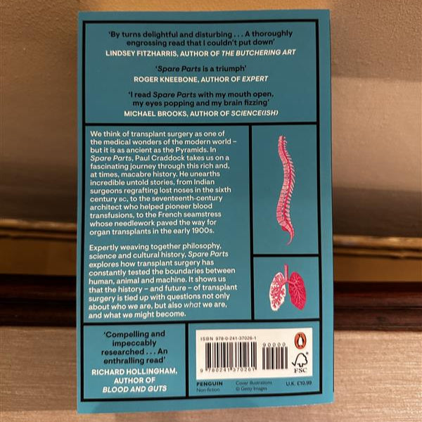 Book back cover with text and illustrations on a wooden surface