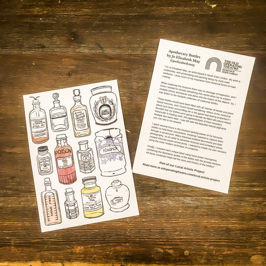 Two cards on a wooden surface, one with the apothecary bottles design and the other showing the text on the back