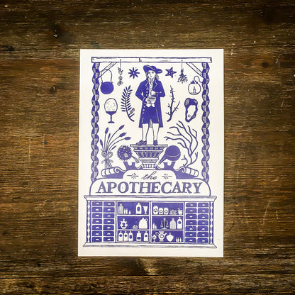 A card on a wooden surface with the blue and white apothecary design