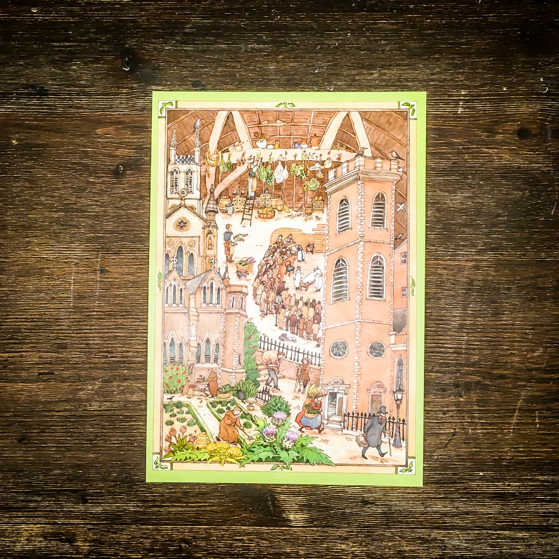 A card on a wooden surface with the design with the museum's building, interior and surroundings