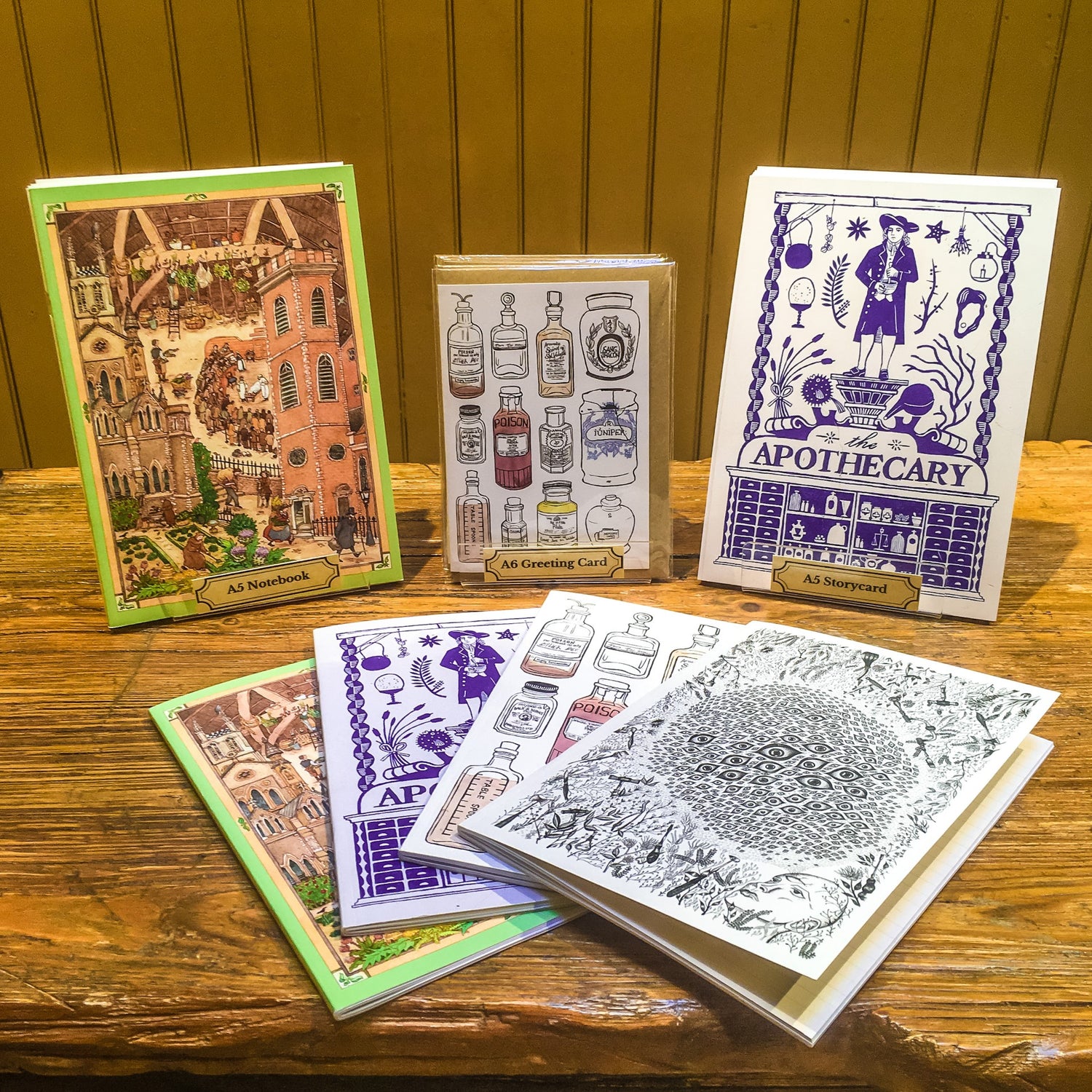 A selection of notebooks in four different designs, displayed on the old operating table