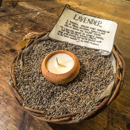A terracotta tealight in a basket of dried lavender