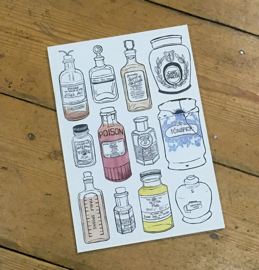 A5 notebook, off-white colour, with lino printed apothecary bottles on cover.