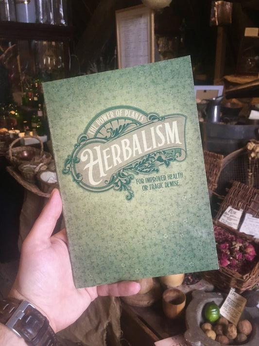 Green notebook. Text: The power of plants. Herbalism. For improved health or tragic demise.