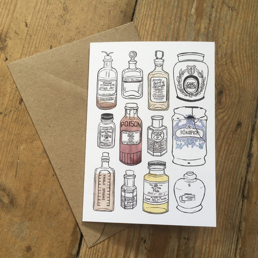 A6 greeting card with lino printed apothecary bottles and brown envelope.