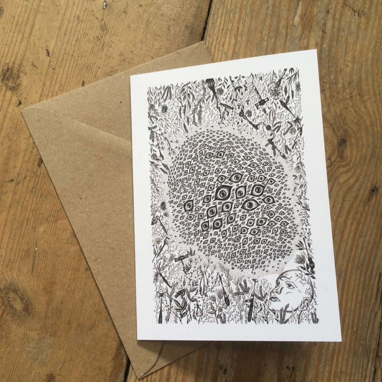 A6 greeting card with black and white trepanation illustration and brown envelope.