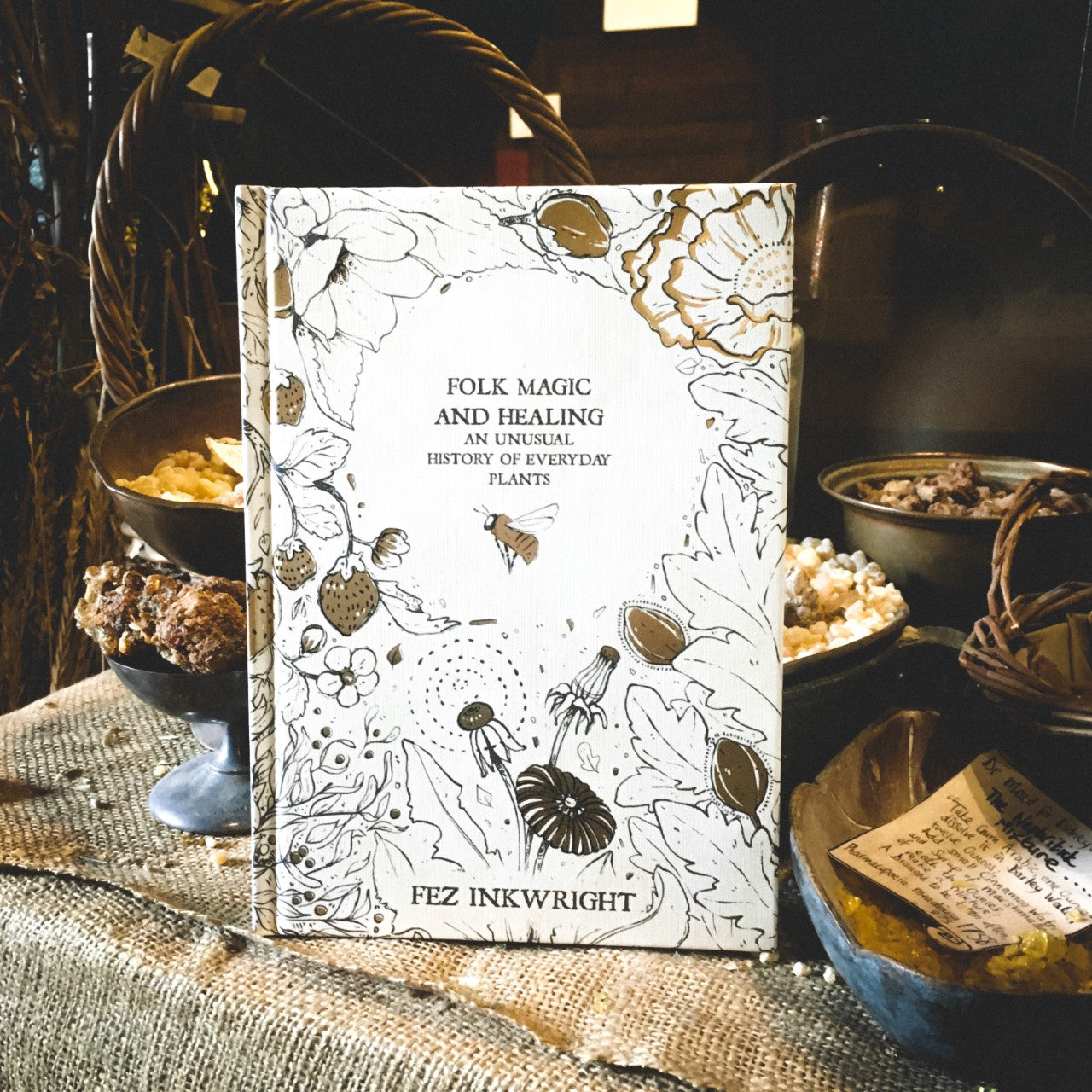 The hardback book Folk Magic and Healing displayed among spices in the museum's herb garret