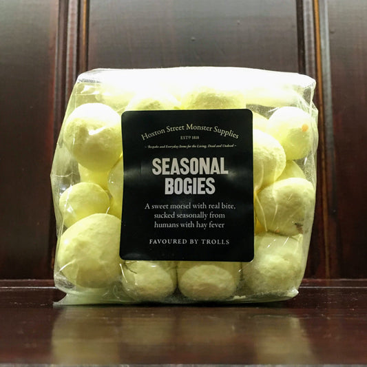 Yellow bonbons in transparent plastic packaging