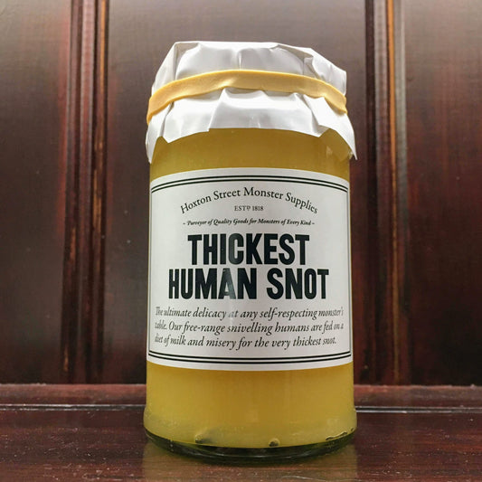 Glass jar containing yellow curd