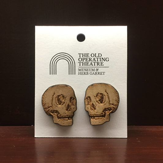Pair of wooden earrings in the shape of a skull