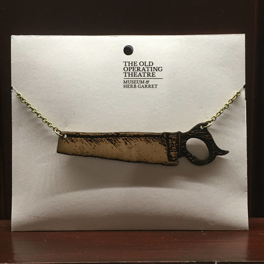 Wooden pendant in the shape of a saw, with a metal chain attached at each end.