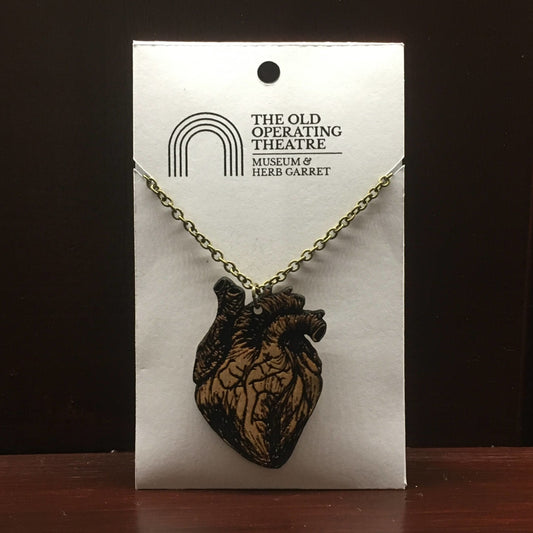 Wooden pendant in the shape of an anatomical heart, on a metal chain