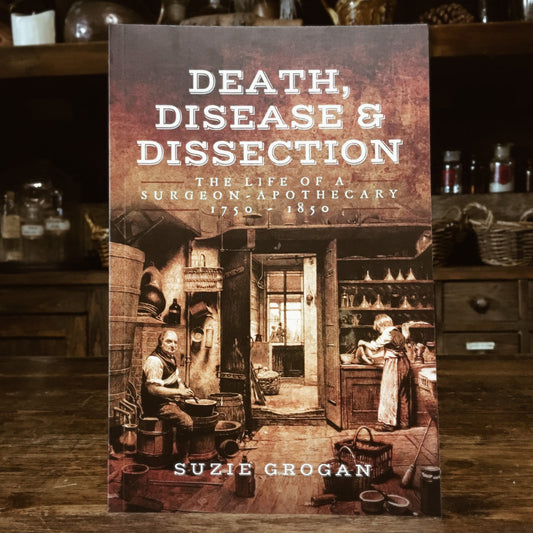 The book Death, Disease and Dissection on a wooden bench in the museum
