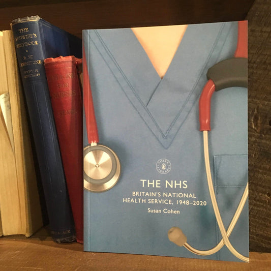 The book The NHS on a bookshelf next to a few old hardback books