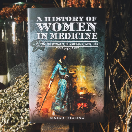 The book A History of Women in Medicine nestled among dried herbs in the herb garret