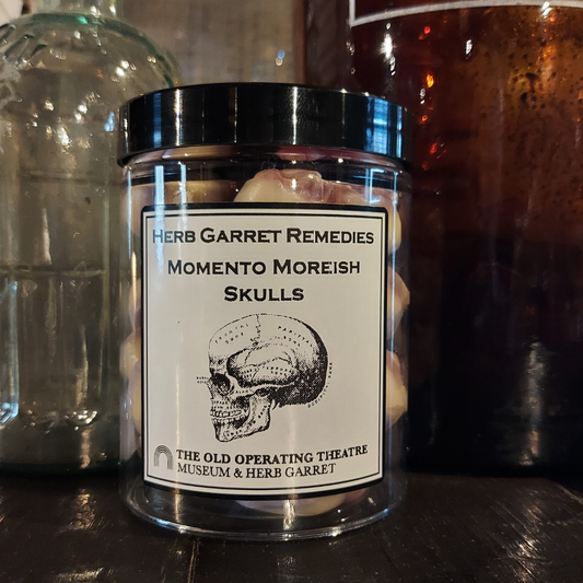 A plastic tub containing sweets, labelled Herb Garret Remedies Momento Moreish Skulls