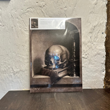 Artwork of a skull on a book with a candle, leaning against a textured wall.