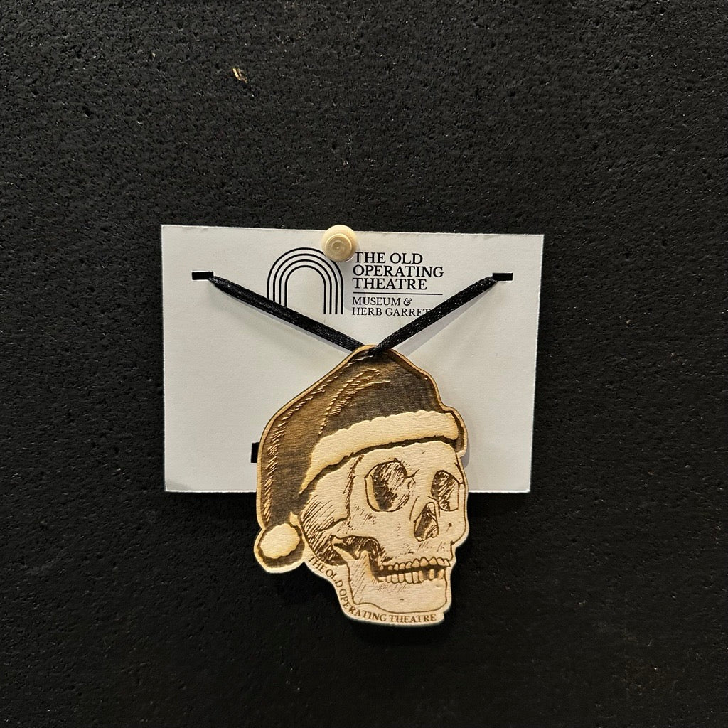 Skull with Santa hat wooden decoration engraved with 'The Old Operating Theatre'
