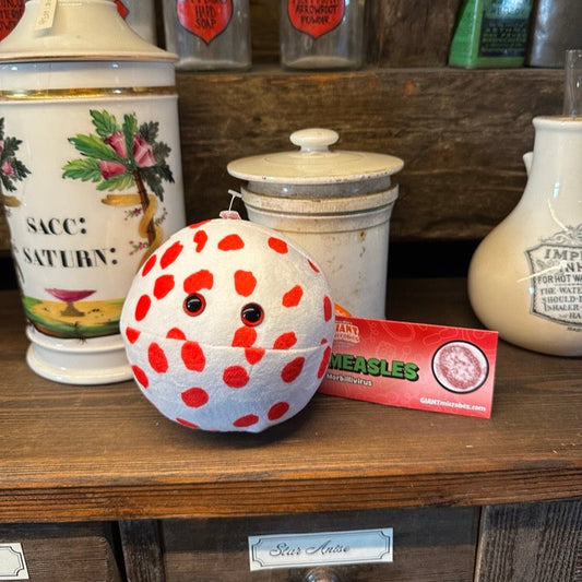 Measles Plush toy on wooden counter