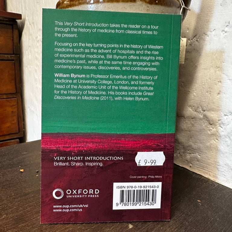 Back cover of a book with text on a wooden surface
