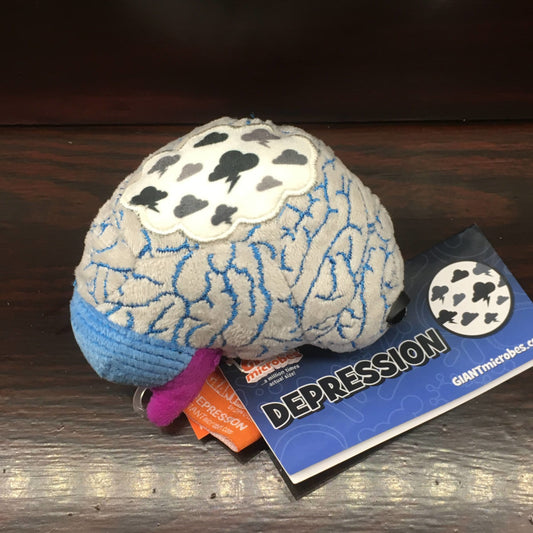 Plush toy in the shape of a brain, with a cloud full of clouds on its surface